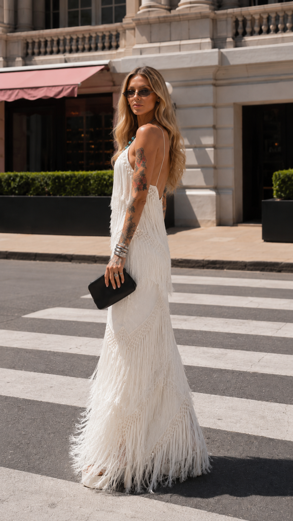 Side view of ivory fringe maxi dress with slim silhouette and flowing hem