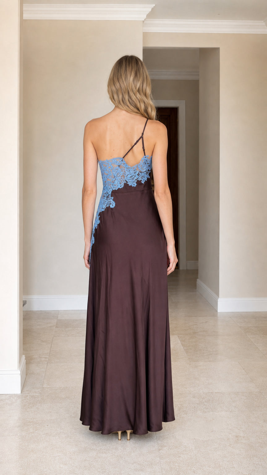 Back view of woman wearing brown one-shoulder satin maxi dress showing strap details