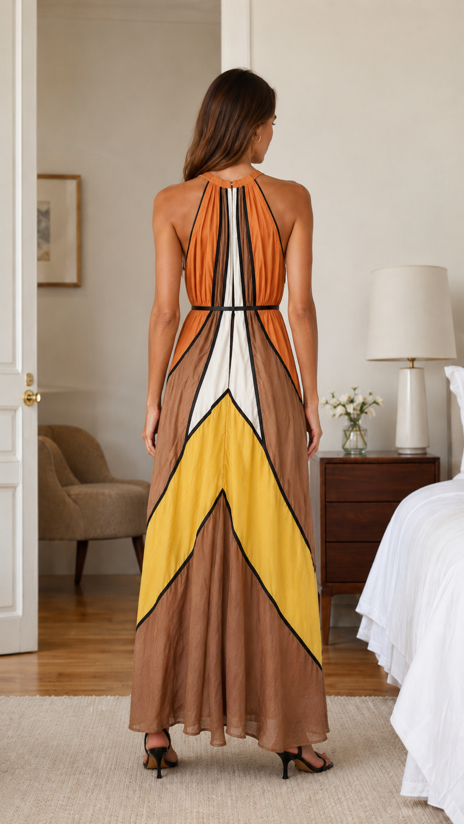 Back view of orange multi halter maxi dress with open shoulder line and contrast trim