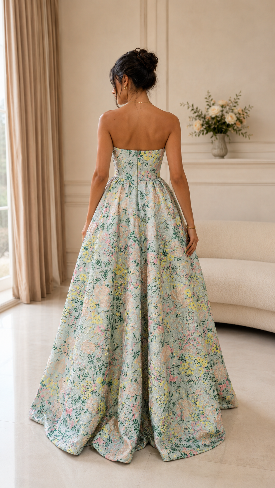 Back view of pastel floral strapless formal gown with voluminous skirt