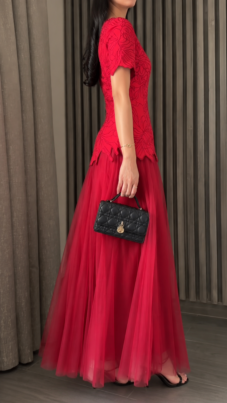 Side view of red short sleeve formal maxi dress with layered tulle skirt