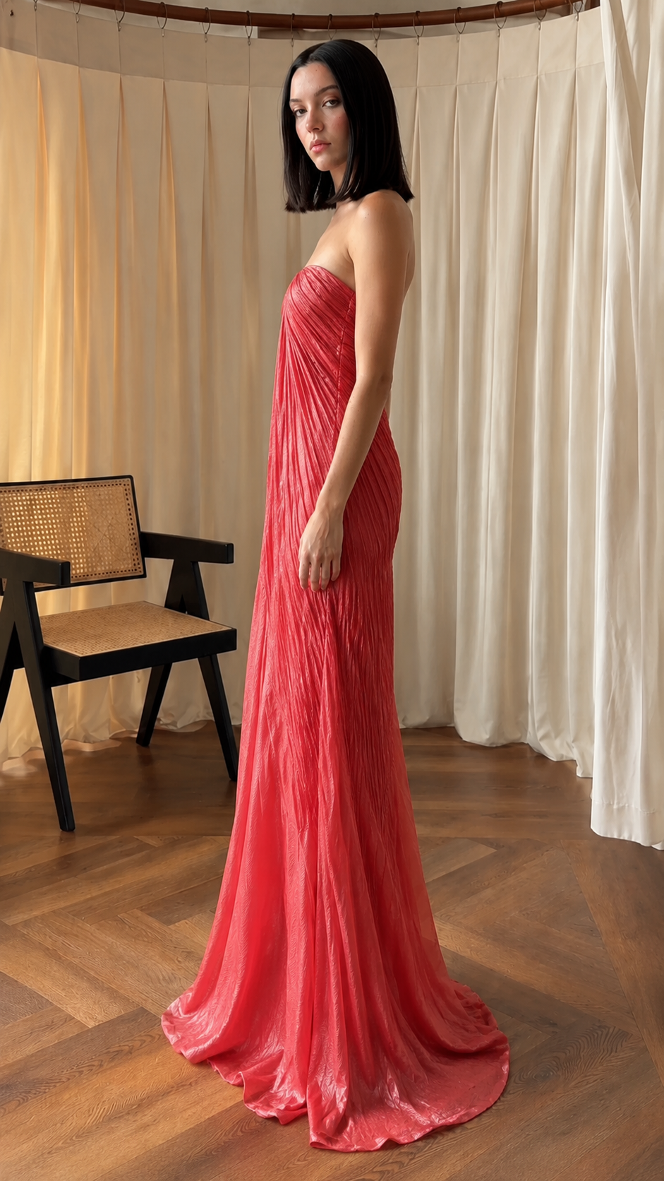 Side view of rose red strapless pleated mermaid evening dress