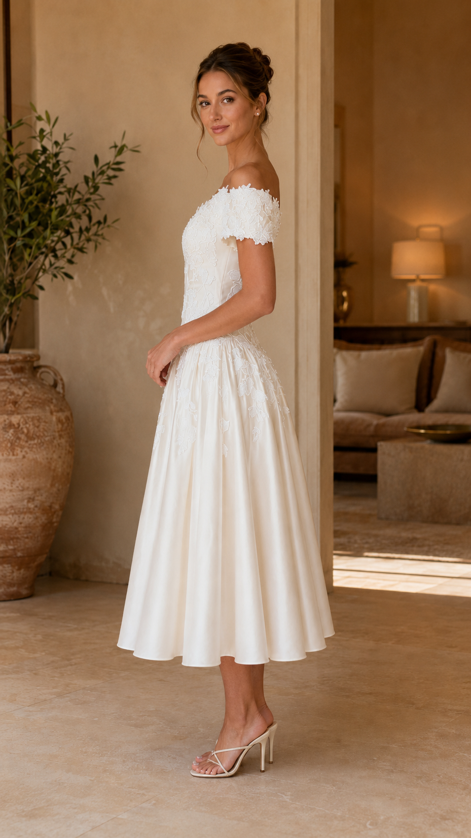 Side view of white off-shoulder lace midi dress with full skirt