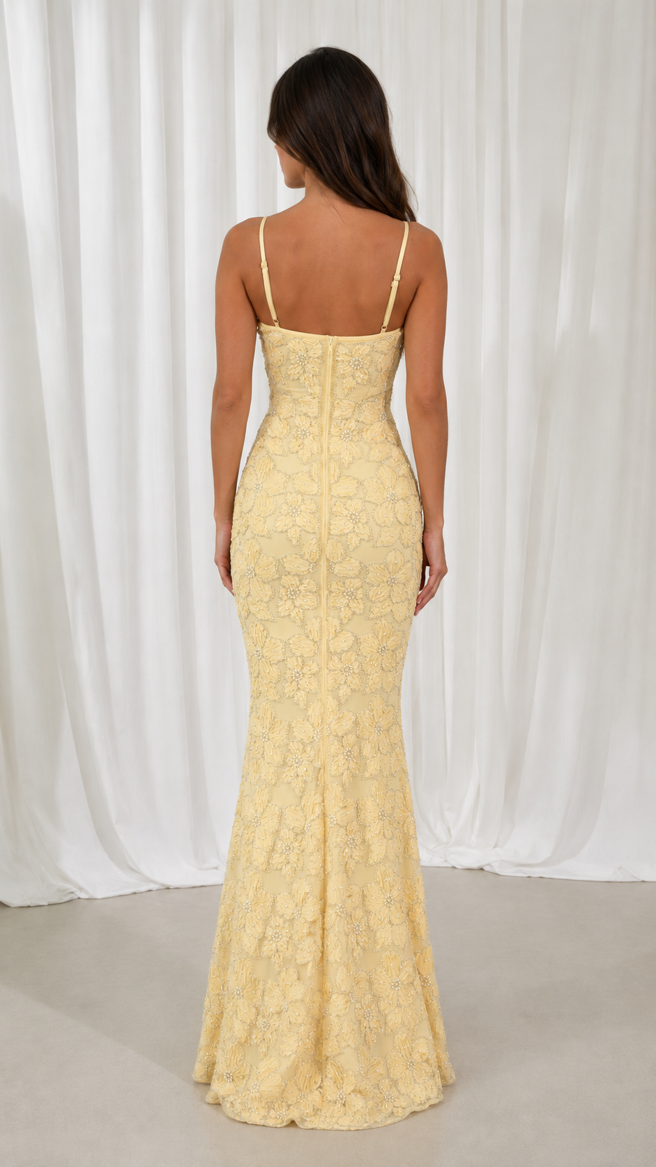 Back view of butter yellow floral lace maxi dress with slim straps and mermaid hem