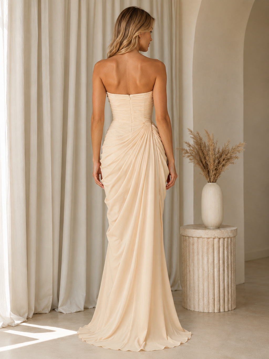 Back view of champagne strapless floor-length ruched evening dress