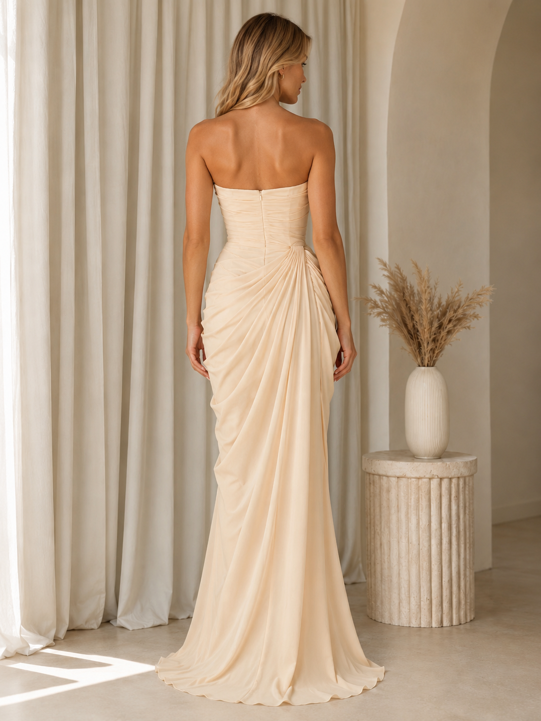 Back view of champagne strapless floor-length ruched evening dress