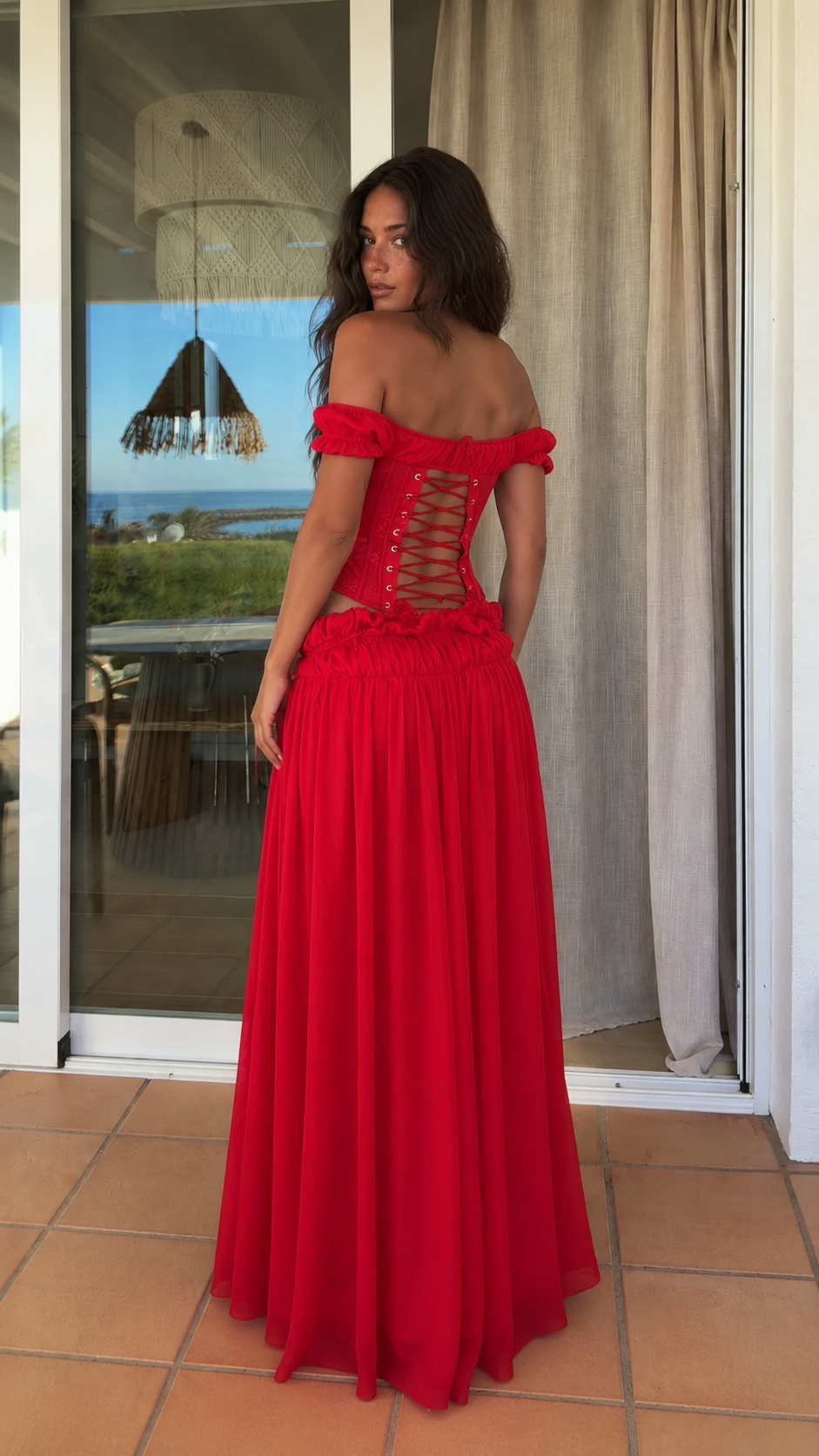 Back view of red set showing lace-up corset detail and full skirt