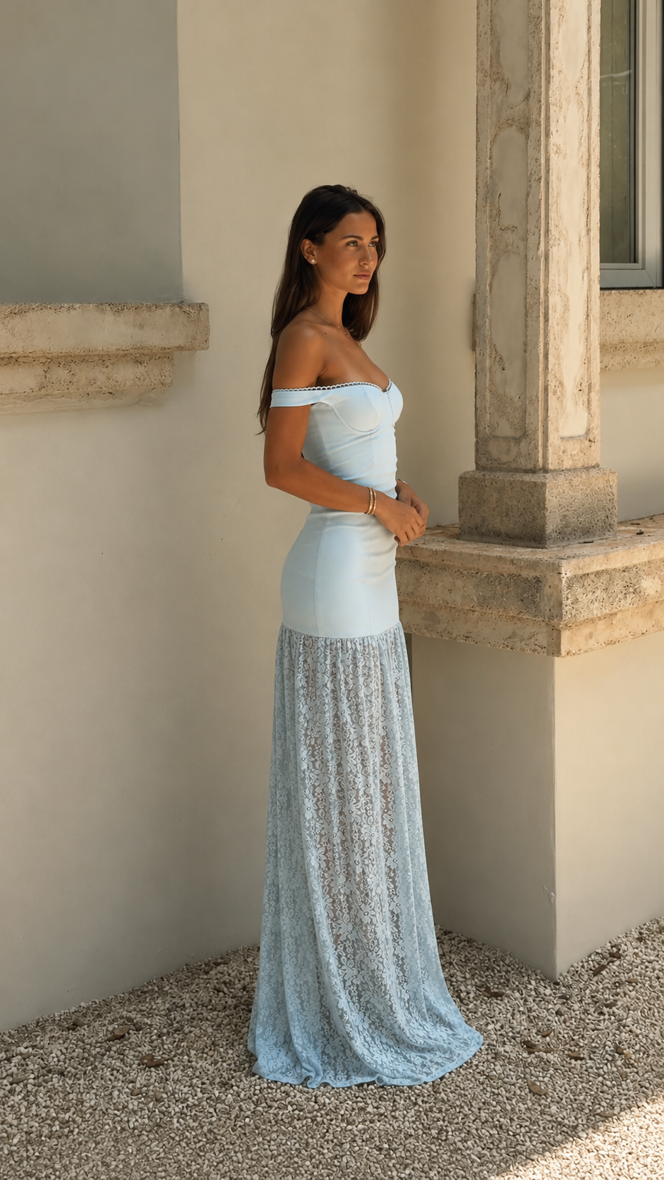 Side view of powder blue sweetheart off-shoulder maxi dress with long textured hem