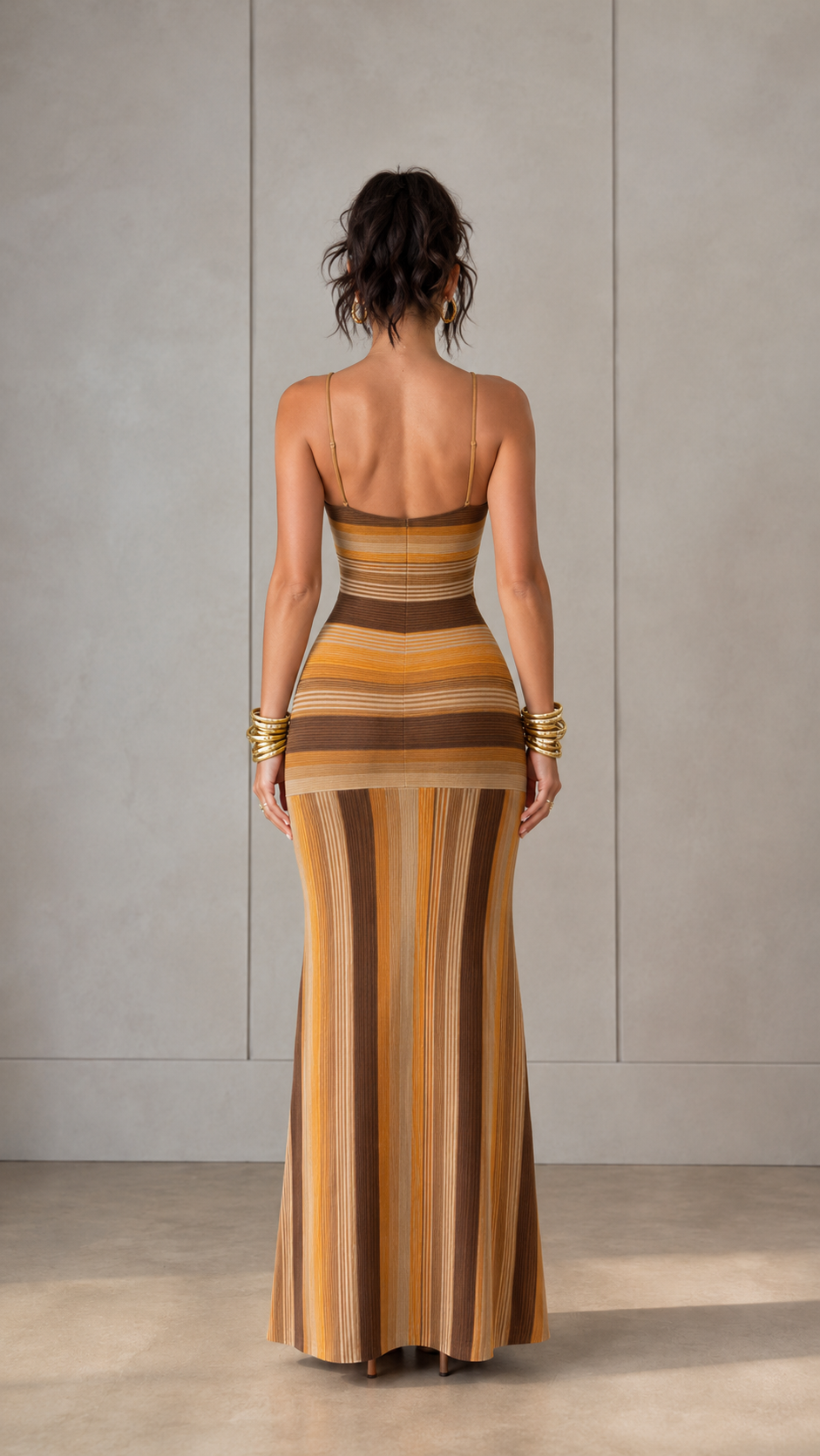 Back view of camel striped maxi dress with slim straps and open back