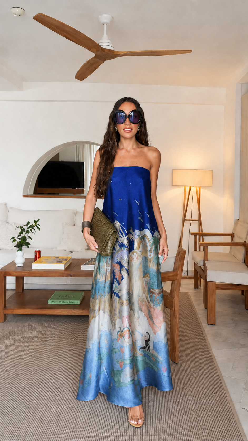 Front view of navy blue strapless printed flowing maxi dress