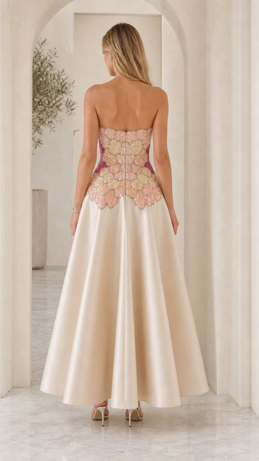 Back view of model in champagne strapless dress