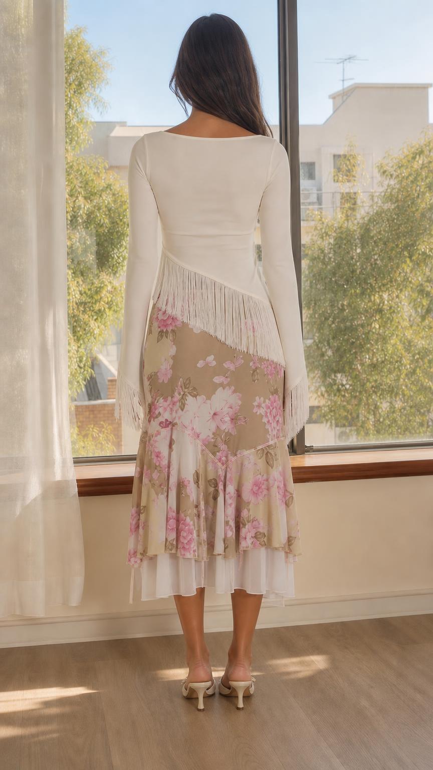 Back view of model showing long sleeves and layered skirt details