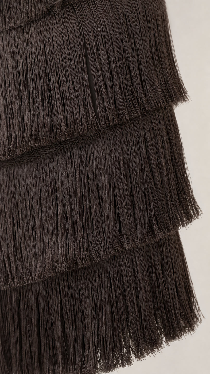 Close up detail of dark brown layered fringe texture