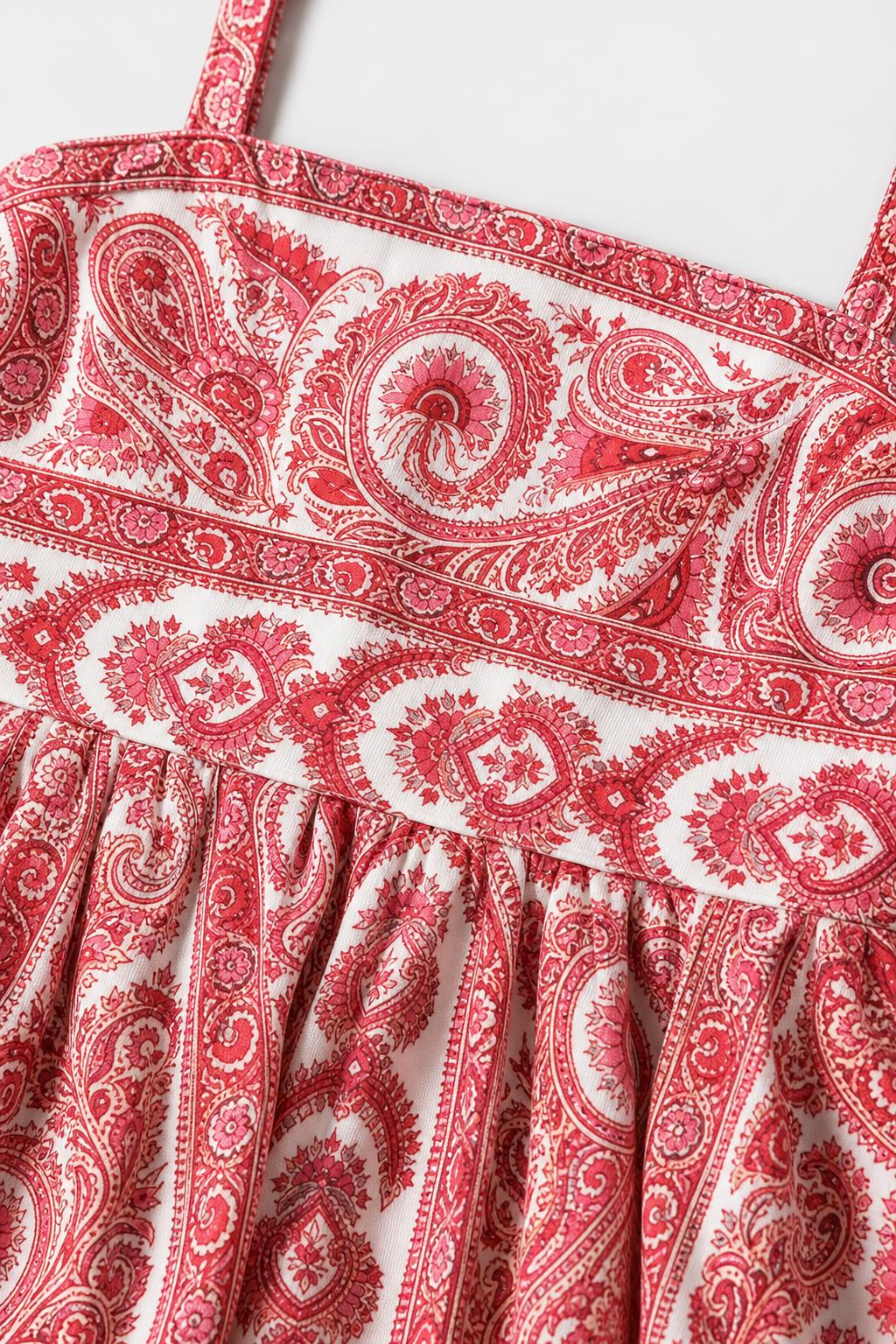 Close-up detail of bodice and pattern on red paisley dress