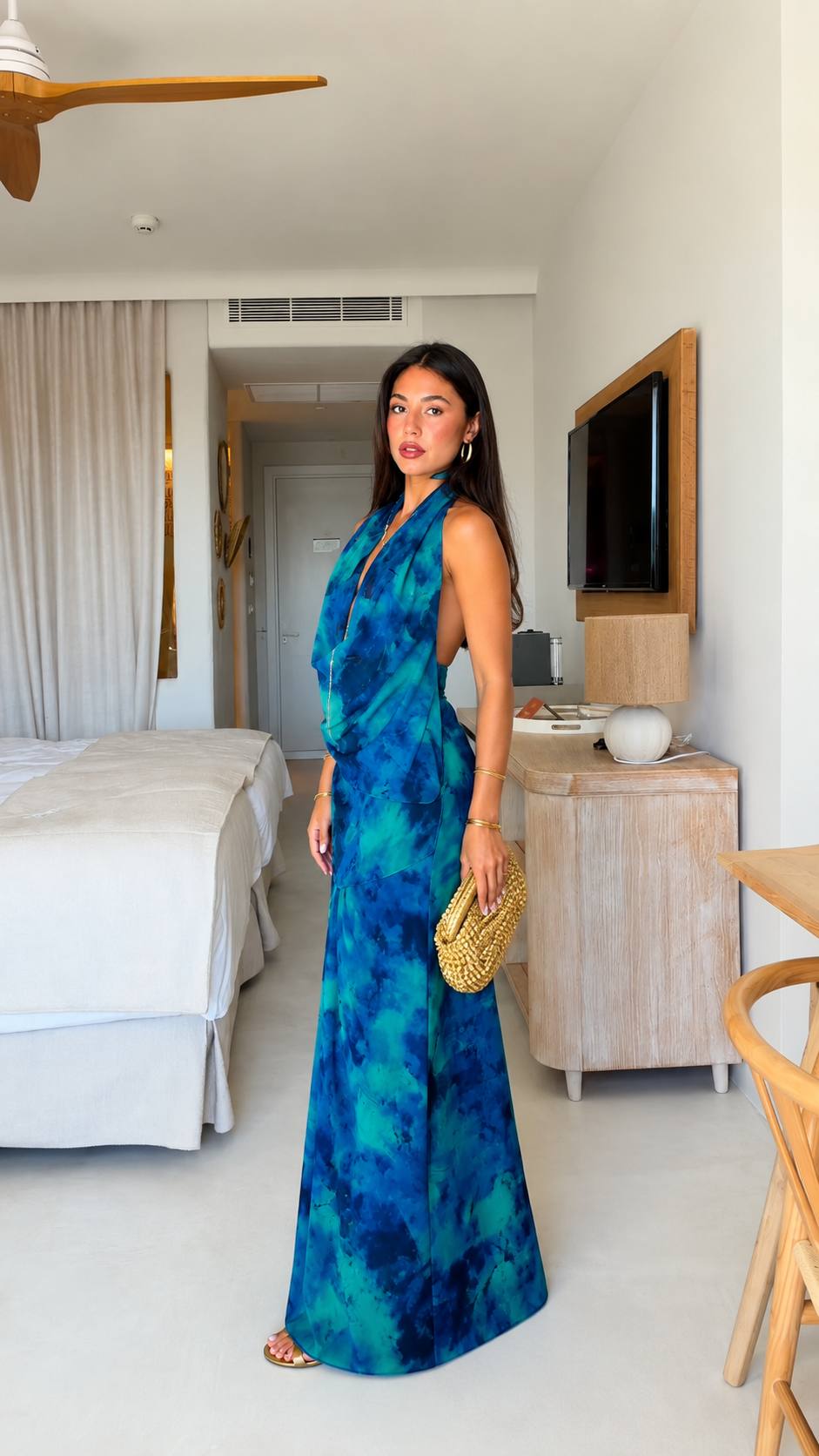 Blue tie-dye halter maxi dress side view with fitted bodice and flowing skirt