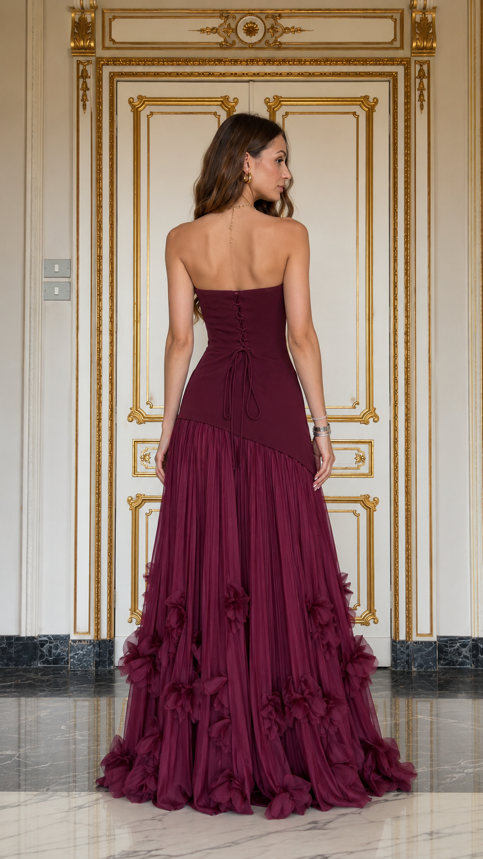 Back view of burgundy strapless maxi gown showing lace-up back detail
