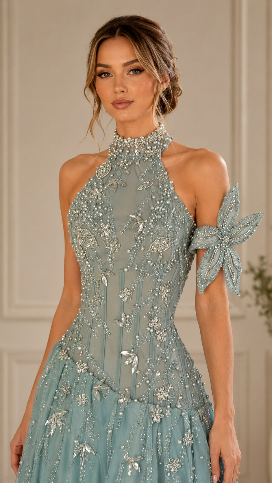 Close-up of dusty blue embellished bodice and halter neckline with floral appliqué