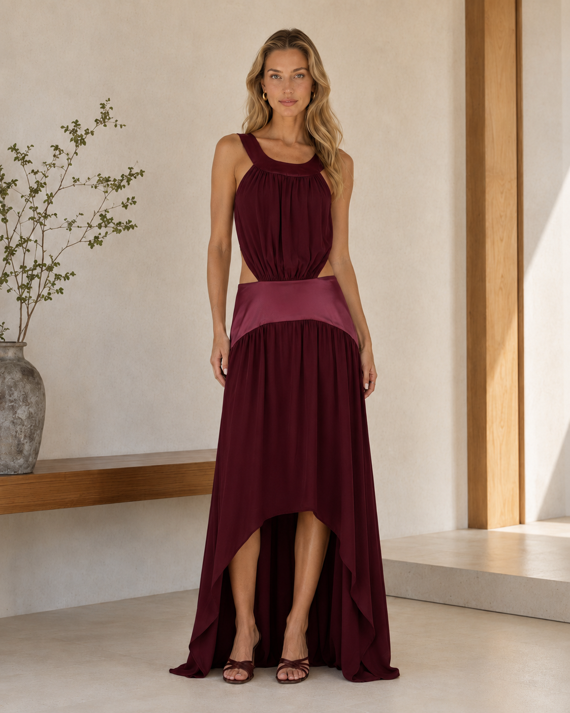 Front view of burgundy gathered bodice cutout maxi dress with high-low hem