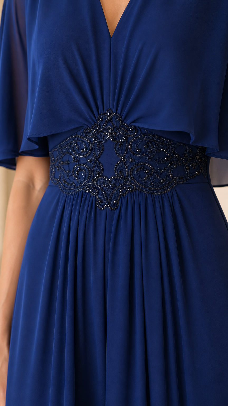 Close-up of beaded waist detail on royal blue evening dress