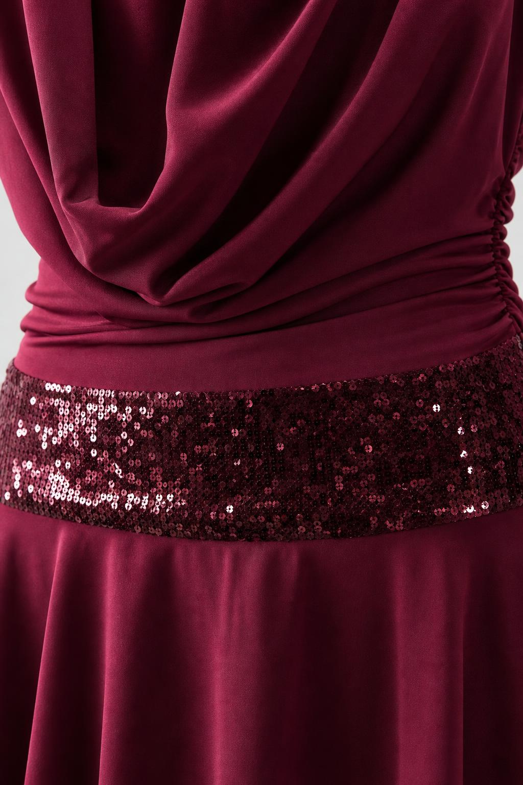 Close-up of cowl neck and sequin waistband detail