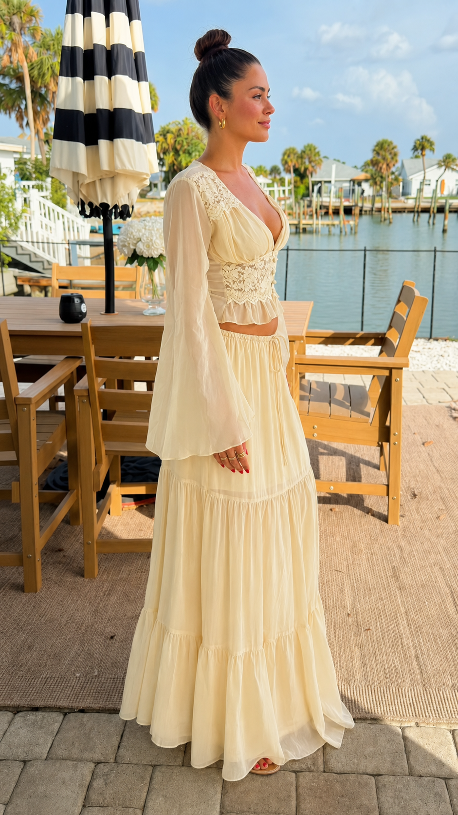 Side view of cream sheer sleeve crop top and maxi skirt set