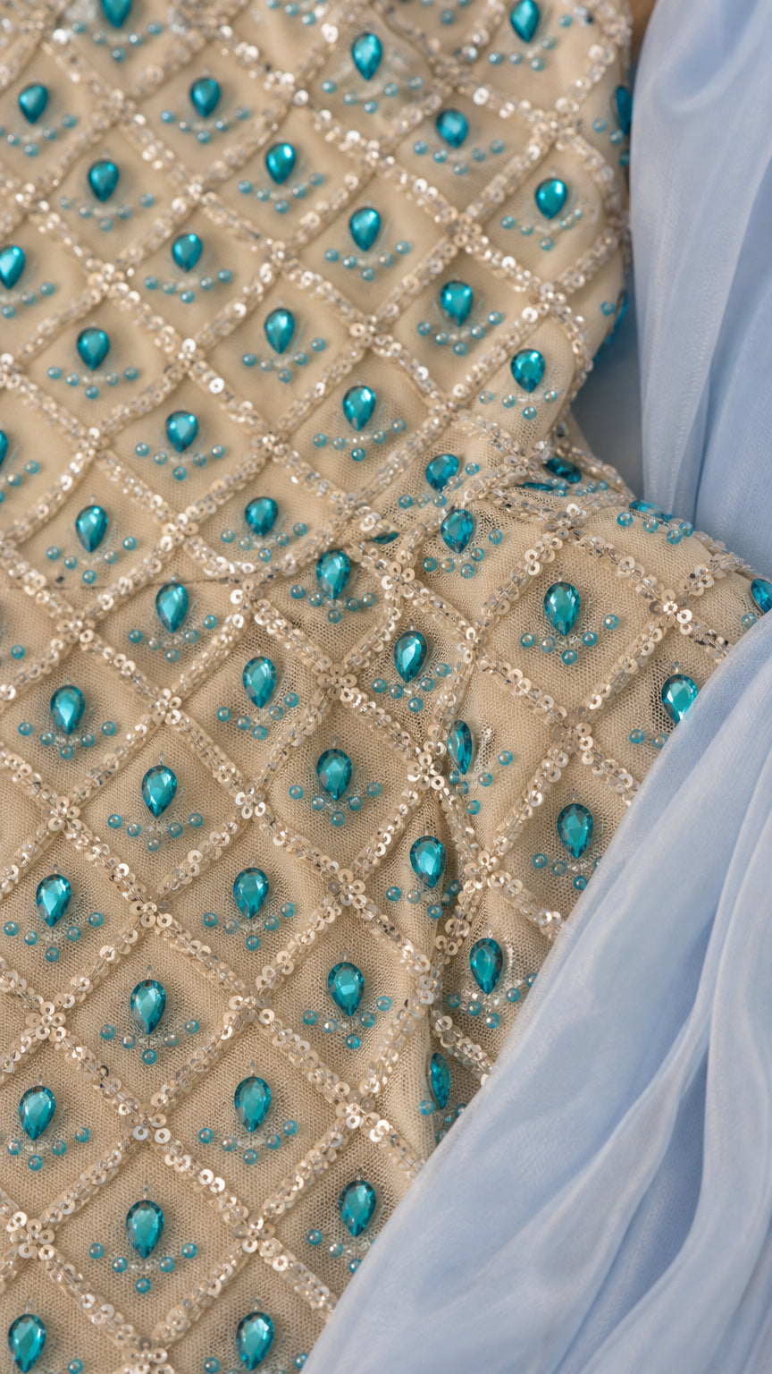 Close-up detail of rhinestone and turquoise crystal beadwork