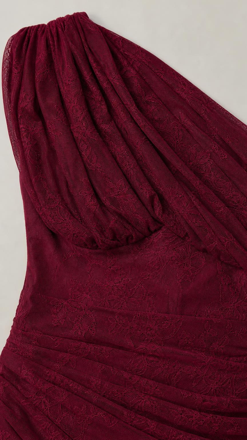 Close-up detail of burgundy lace texture and ruching