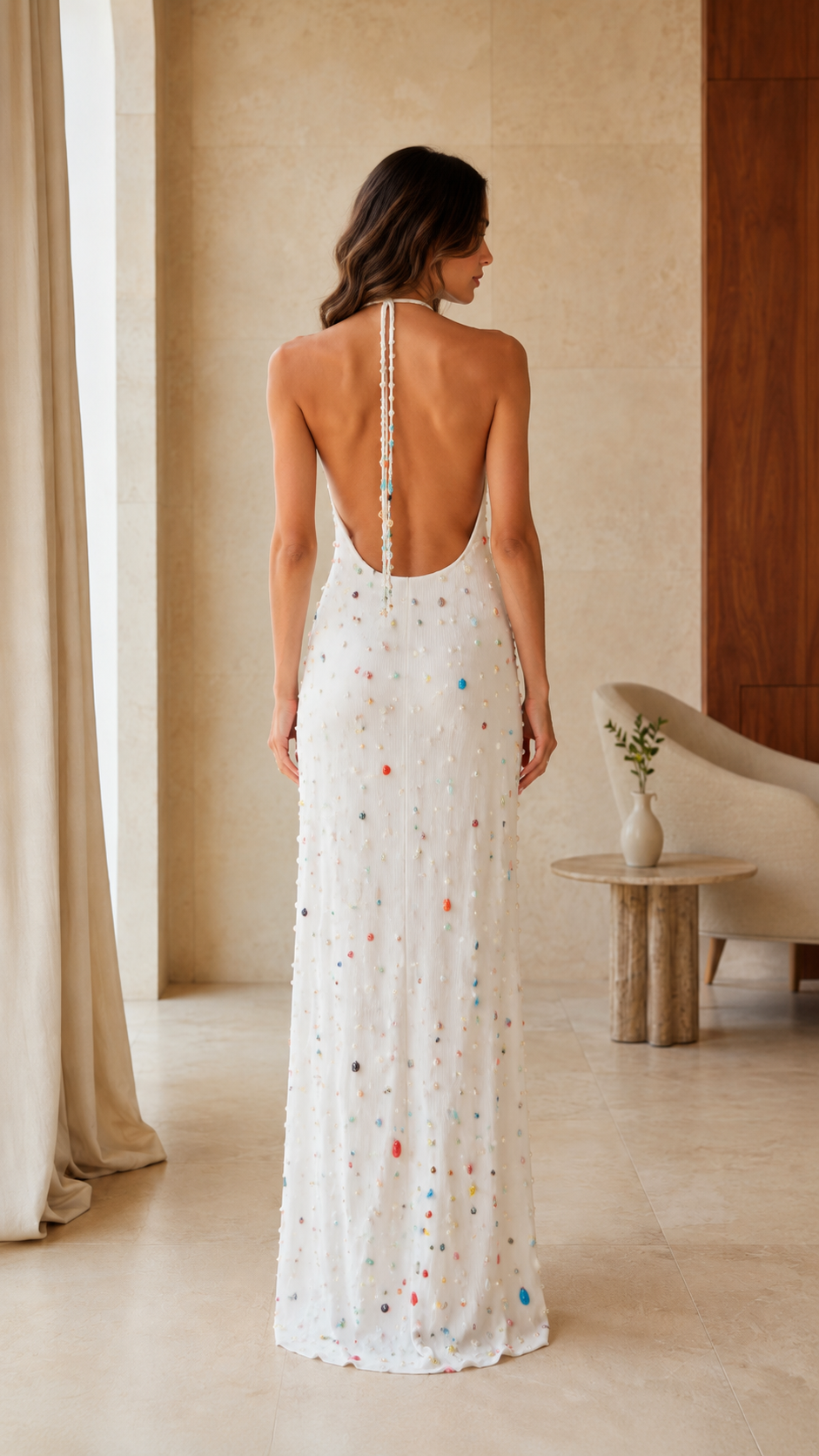 Back view of white embellished halter maxi dress with low open back