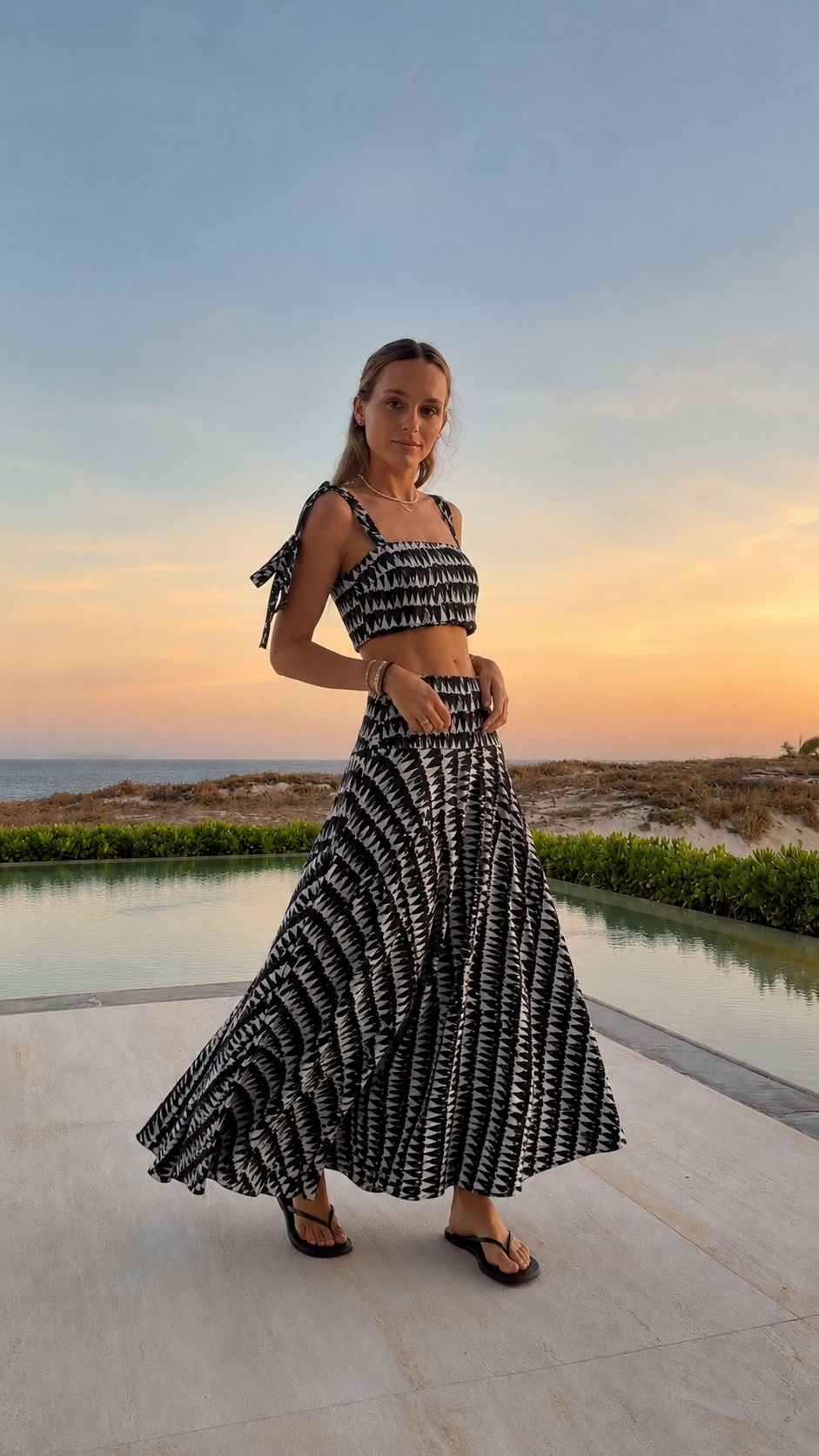Angled view of black printed matching crop top and maxi skirt set