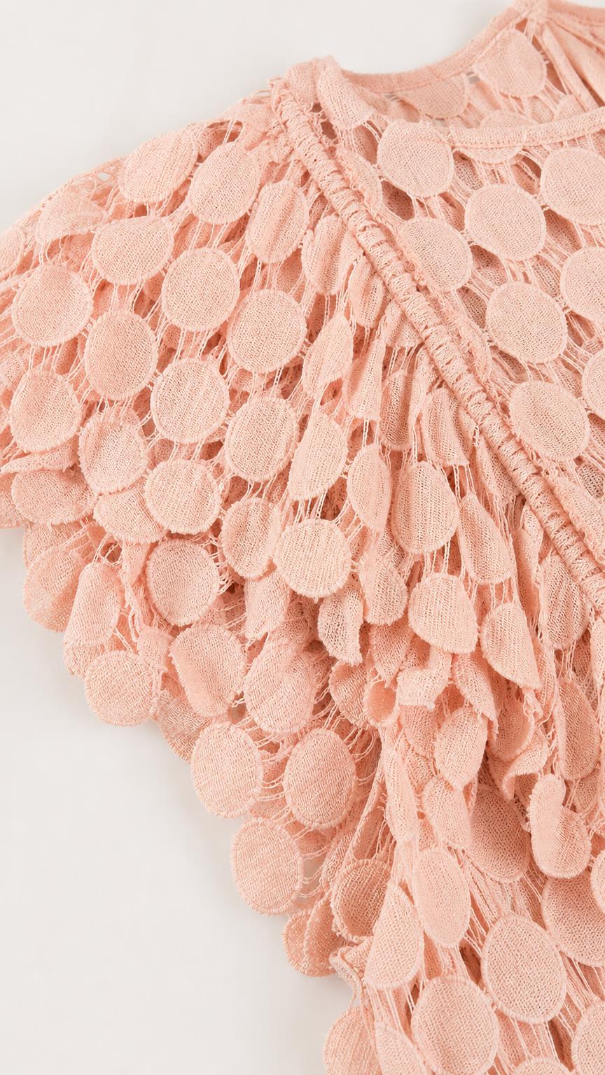 Close-up of pink dress textured circle fabric and shoulder ruffles