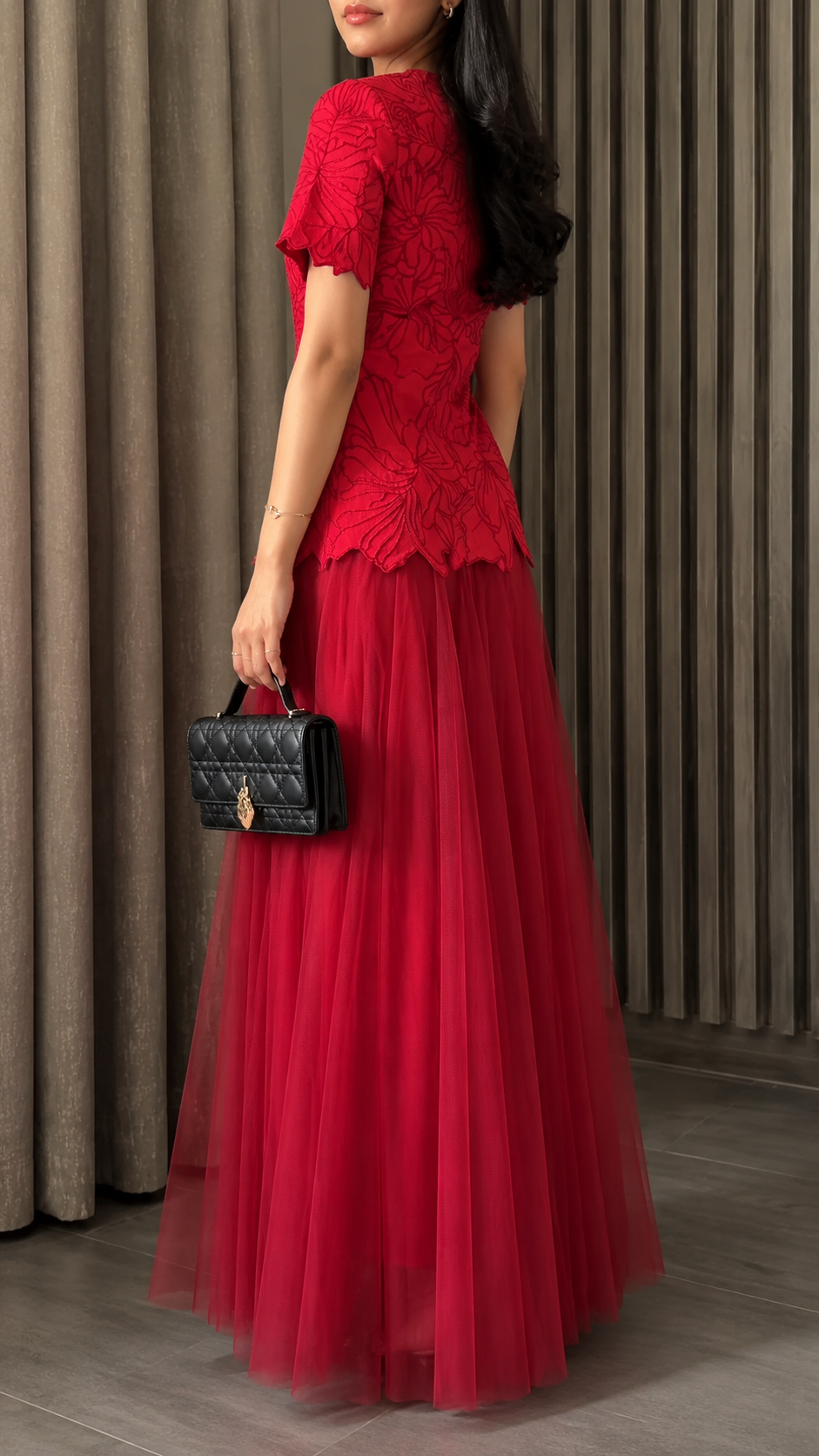 Back side view of red floral bodice evening gown with floor-length skirt