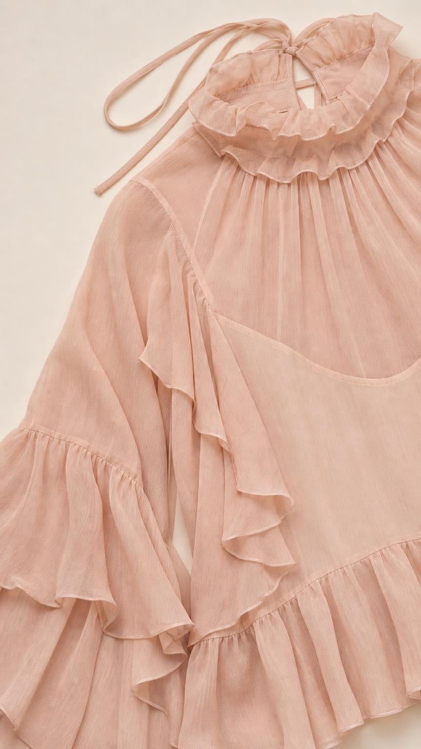 Close-up detail of ruffles, collar, and tie closure