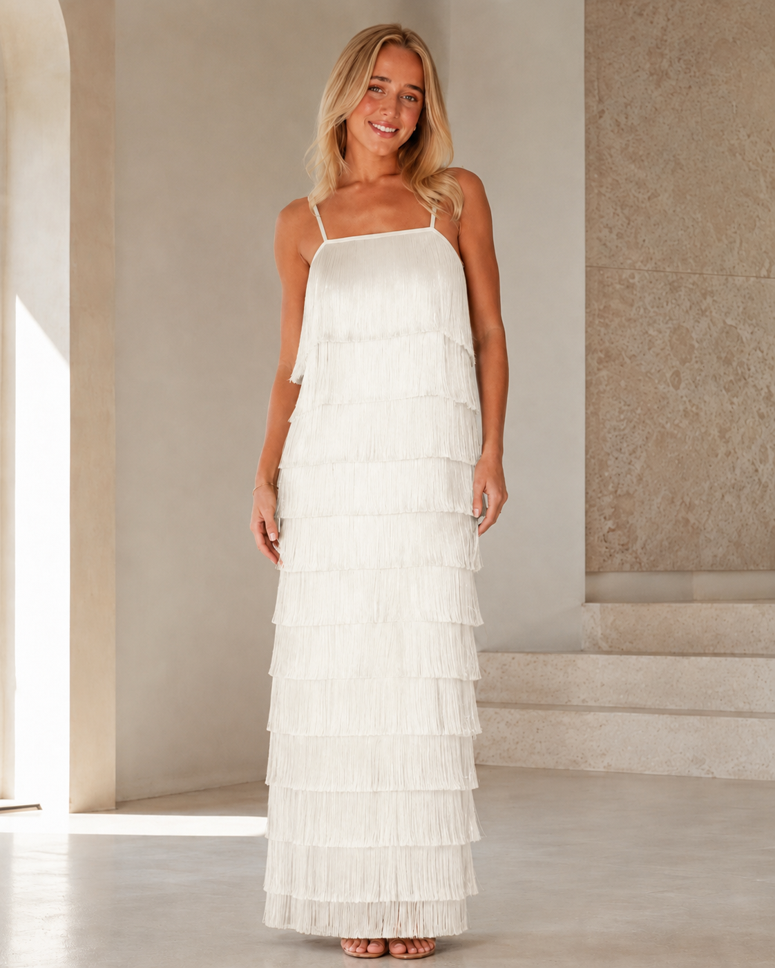 Full front view of white tiered fringe maxi dress with square neckline