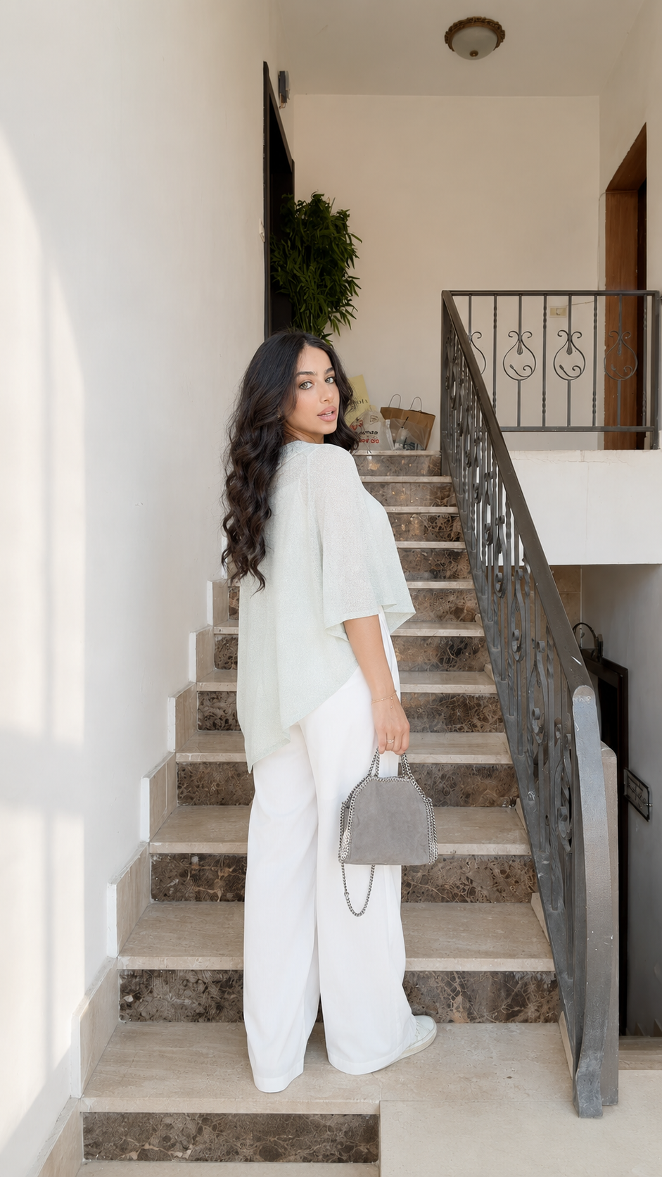 Back view of sage relaxed knit top with poncho silhouette and elbow sleeves