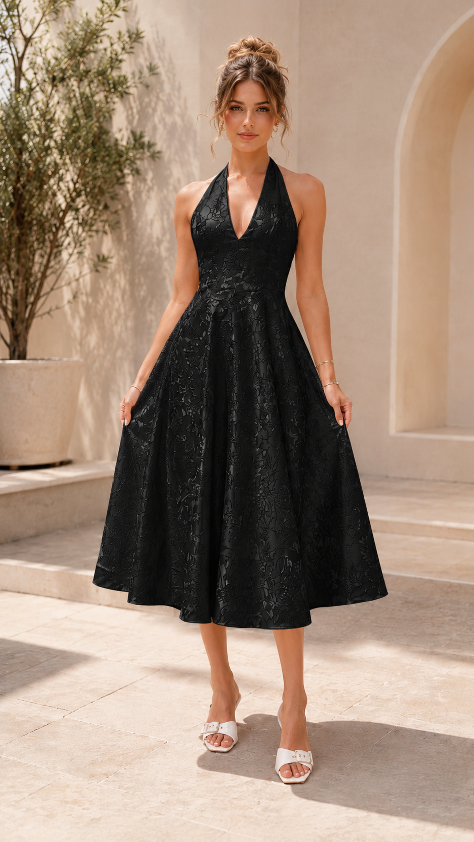 Front view of black halter midi A-line dress with textured finish