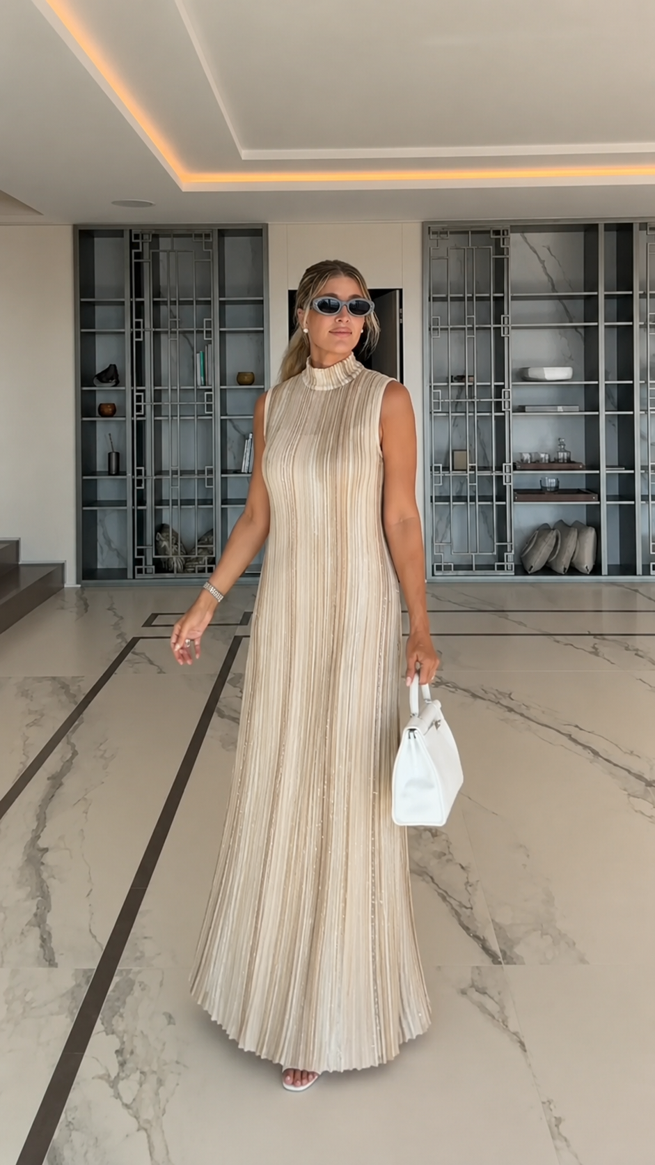 Front view of champagne pleated mock neck sleeveless maxi dress
