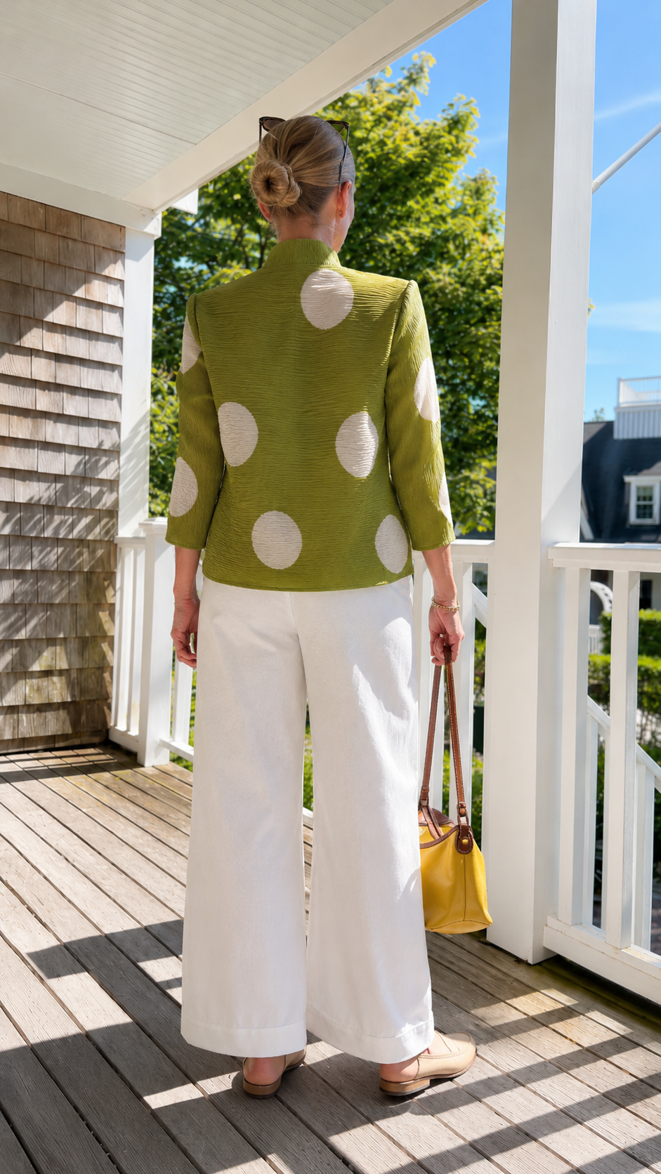 Back view of olive green pleated polka dot jacket top with bracelet-length sleeves