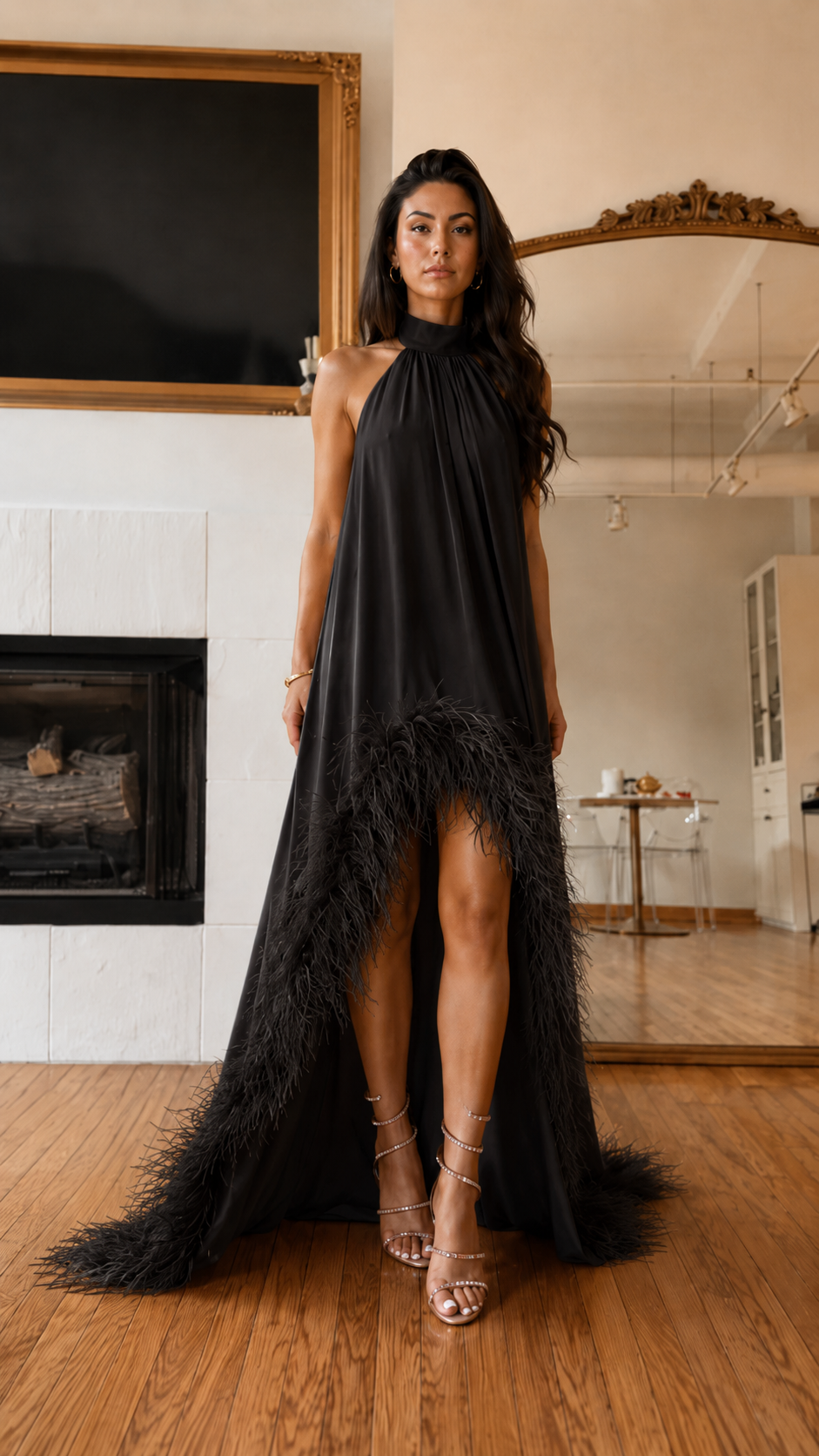 Front view of black halter high-low maxi dress with feather trim hem