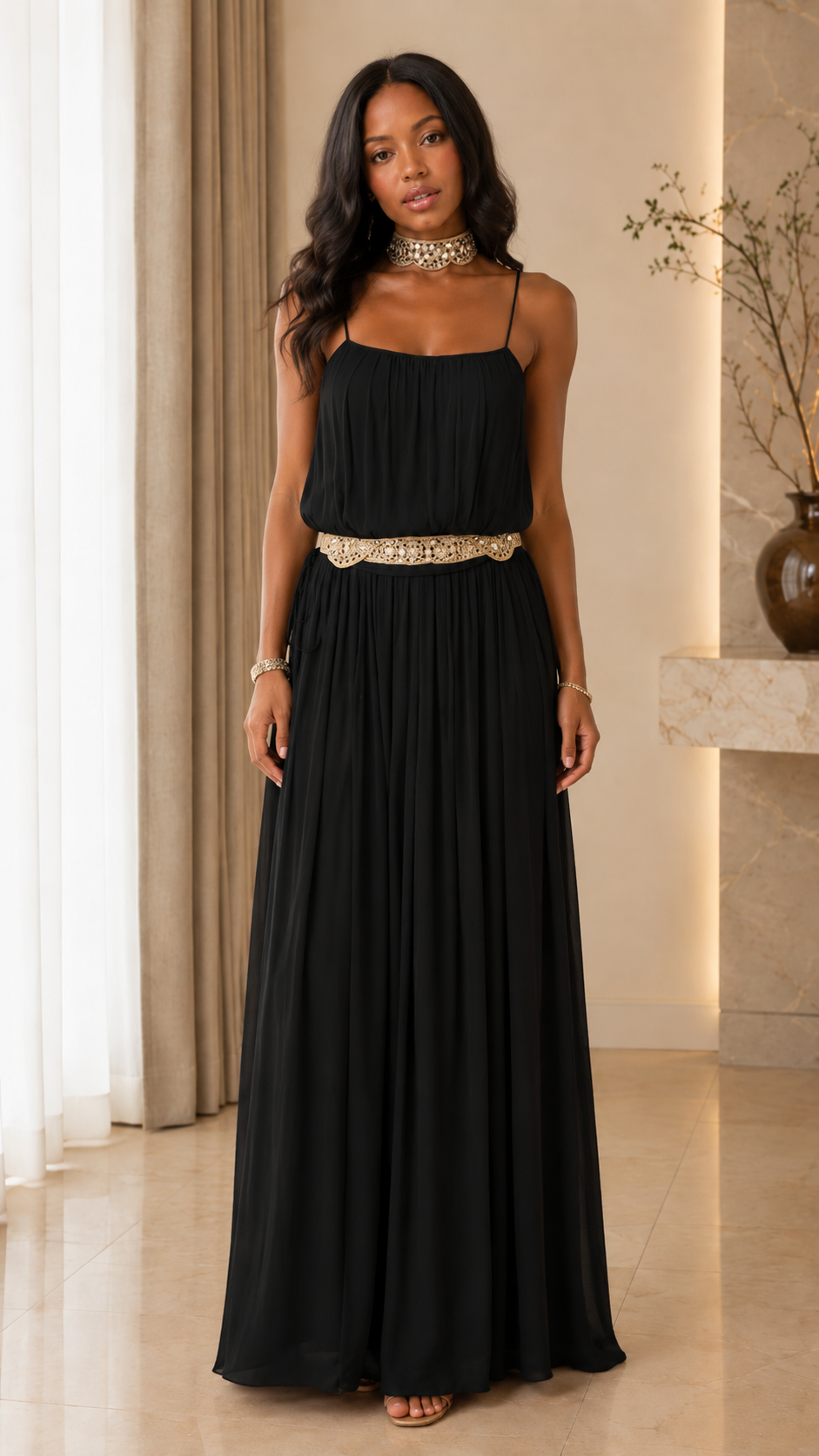 Front view of black pleated maxi dress with spaghetti straps and embellished waist