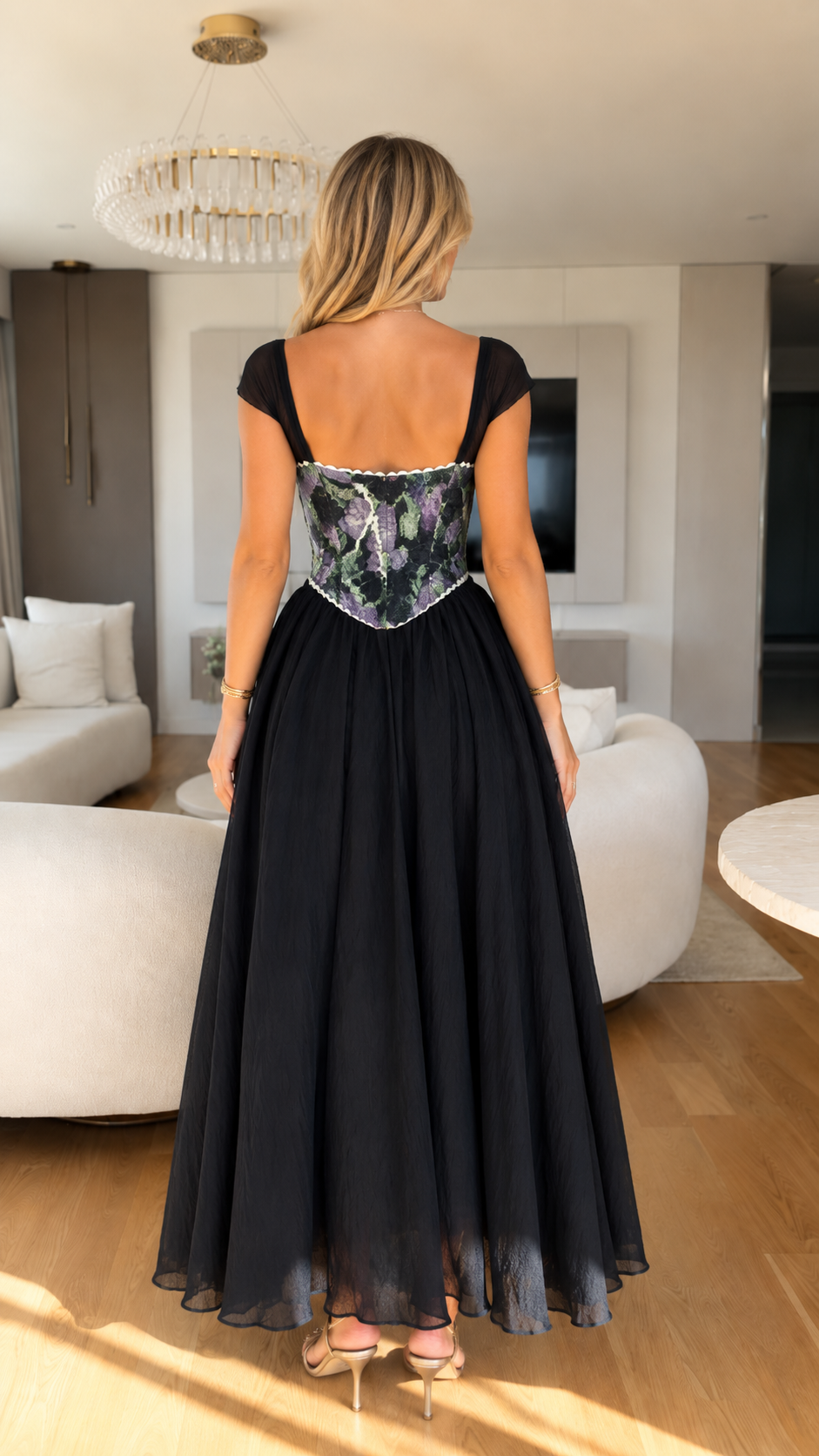 Back view of black floral corset bodice maxi dress showing cap sleeves and full skirt