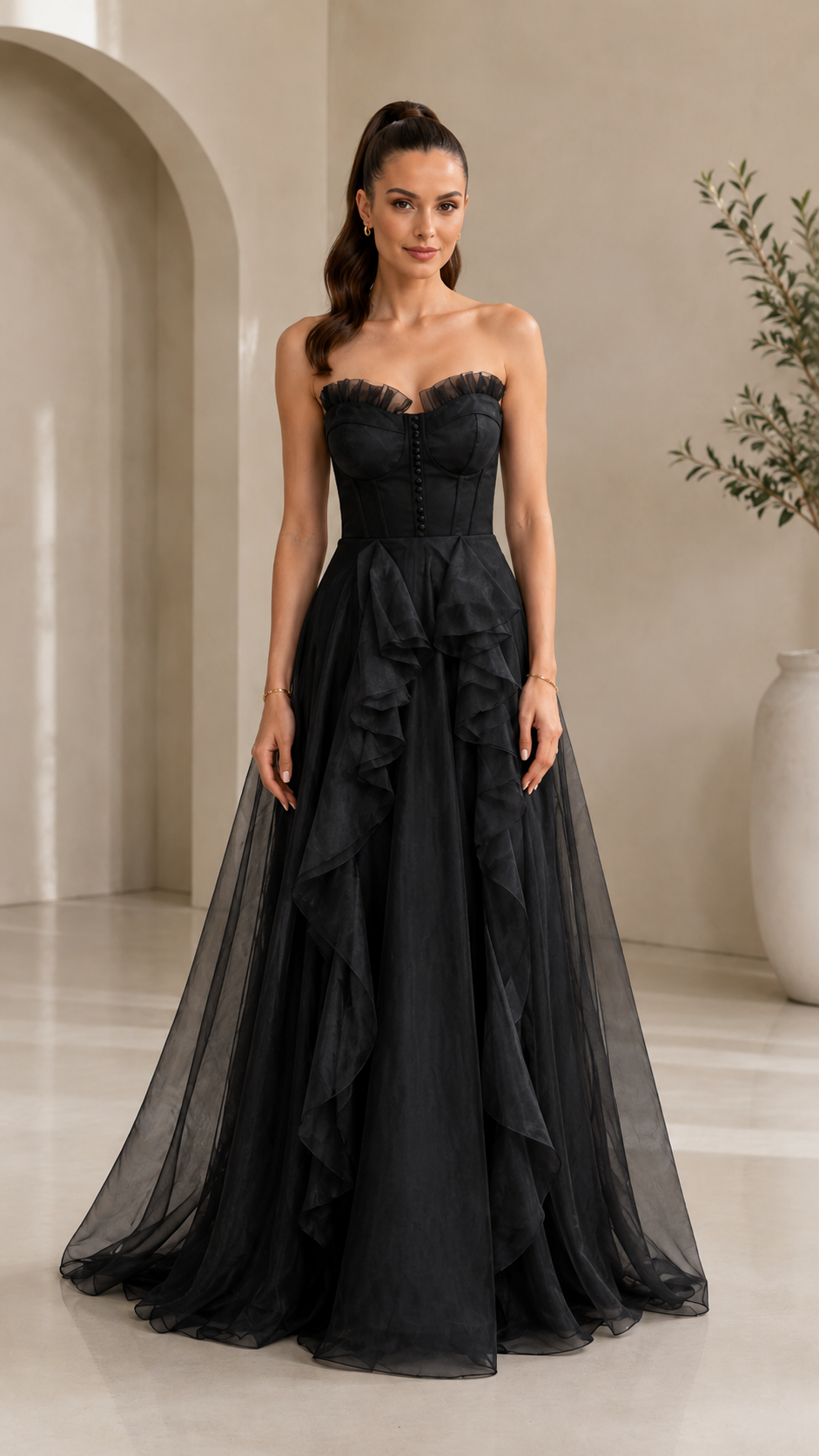 Front view of black strapless corset evening gown with cascading ruffle front detail