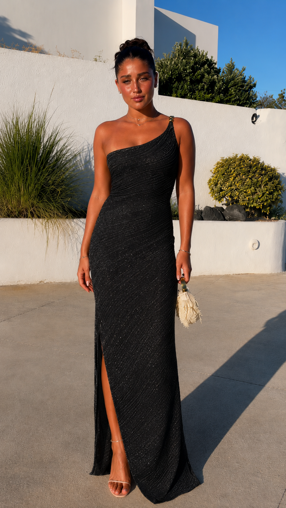Front view of black one-shoulder ruched maxi dress with side slit