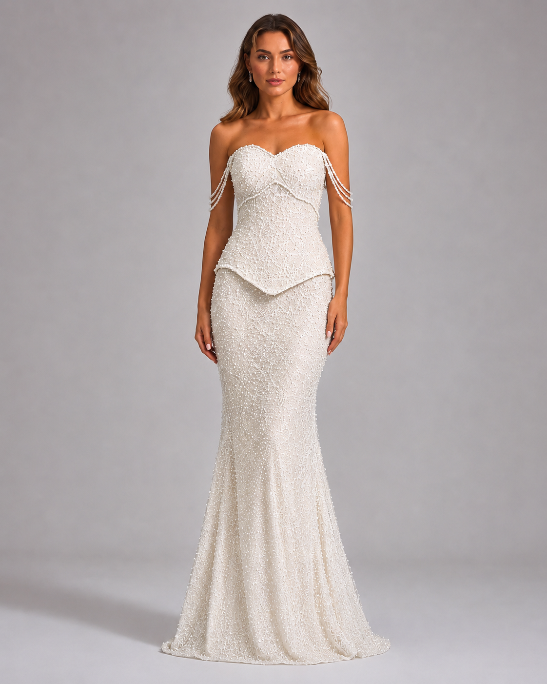 Front view of ivory beaded strapless mermaid gown with sculpted waist