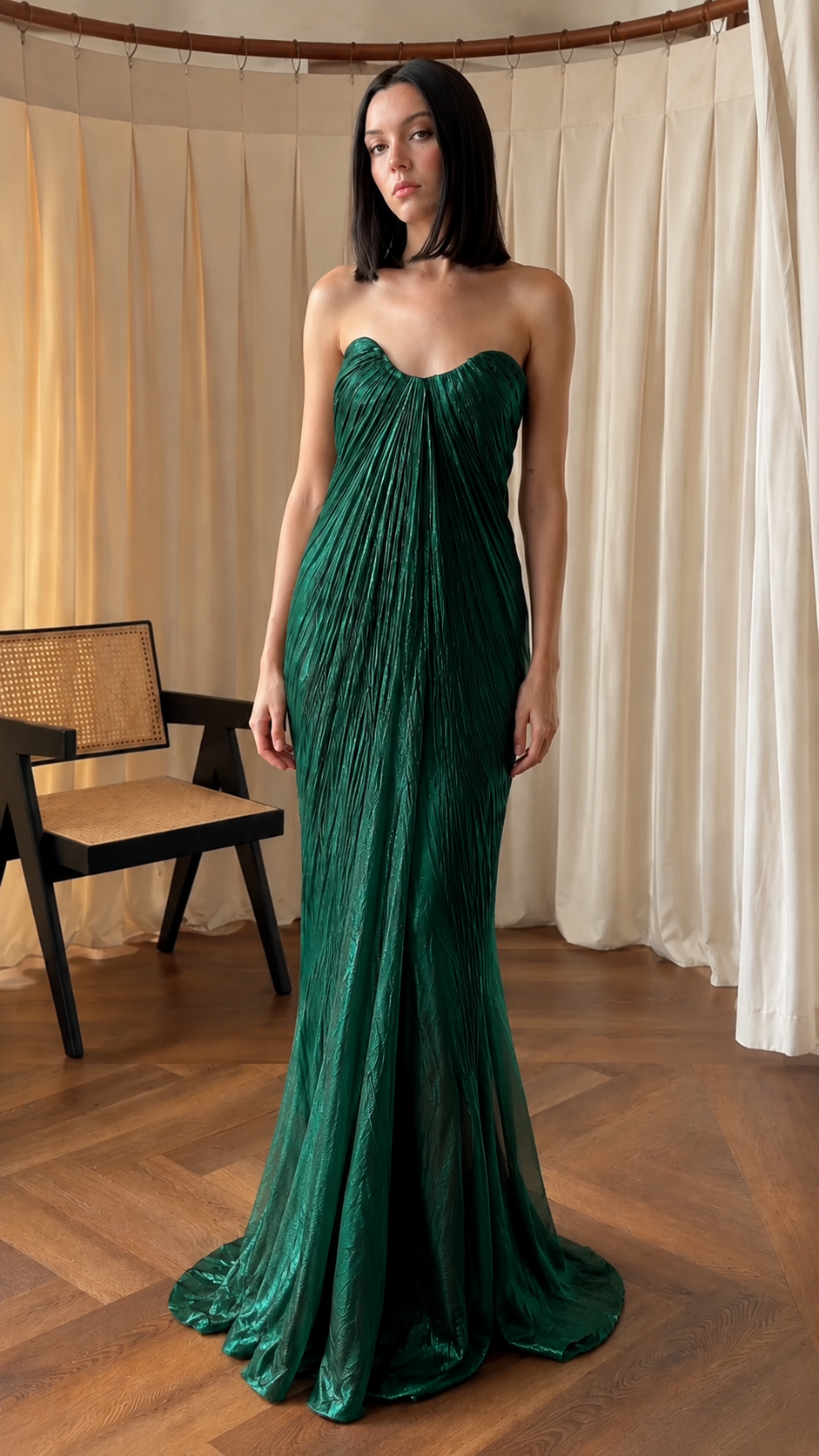 Front view of emerald strapless pleated floor-length evening gown