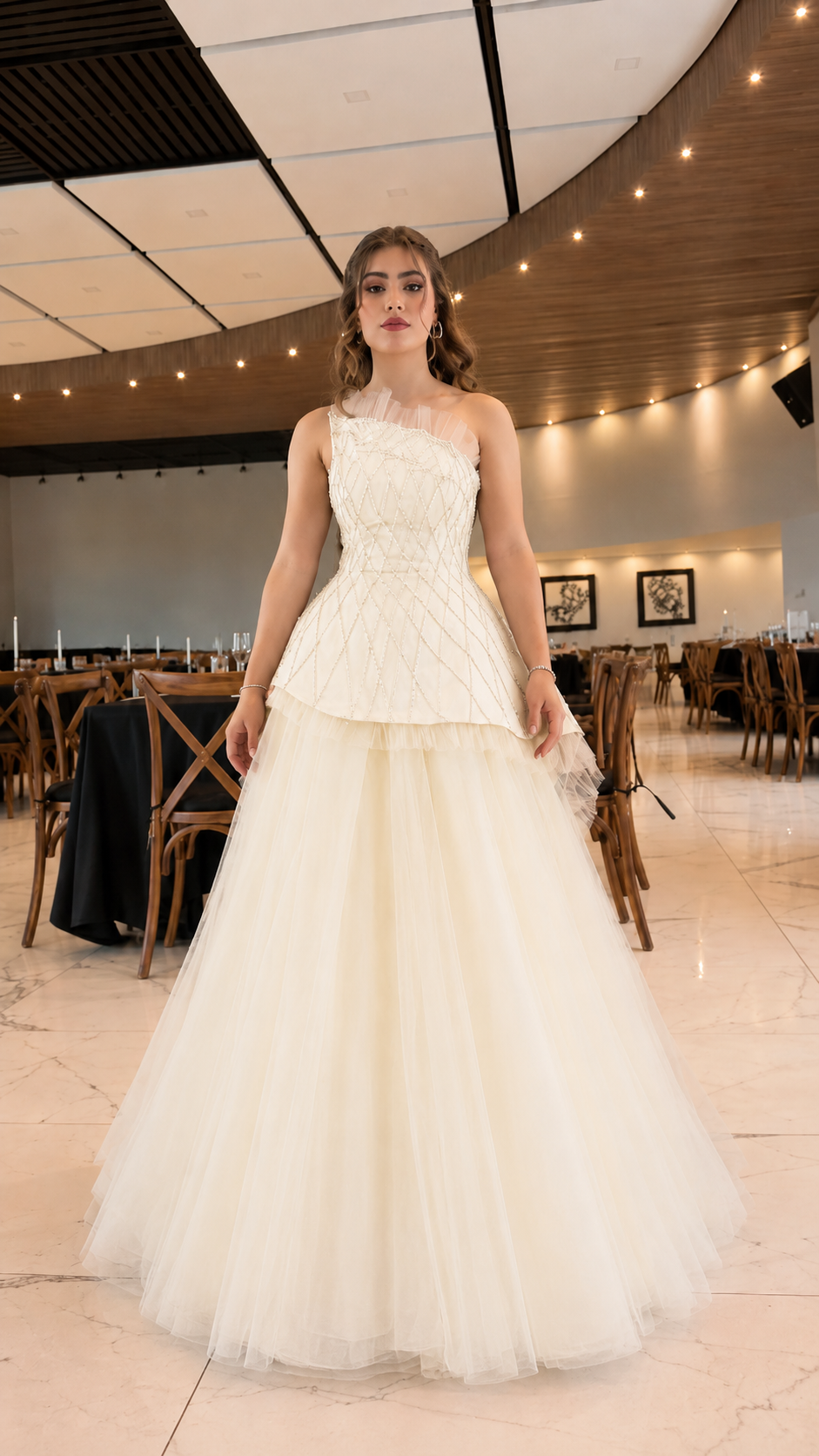 Front view of ivory one-shoulder formal gown with layered tulle skirt
