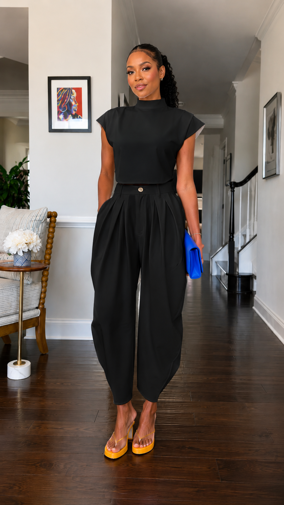 Front view of black mock neck cap sleeve harem jumpsuit with clean structured neckline
