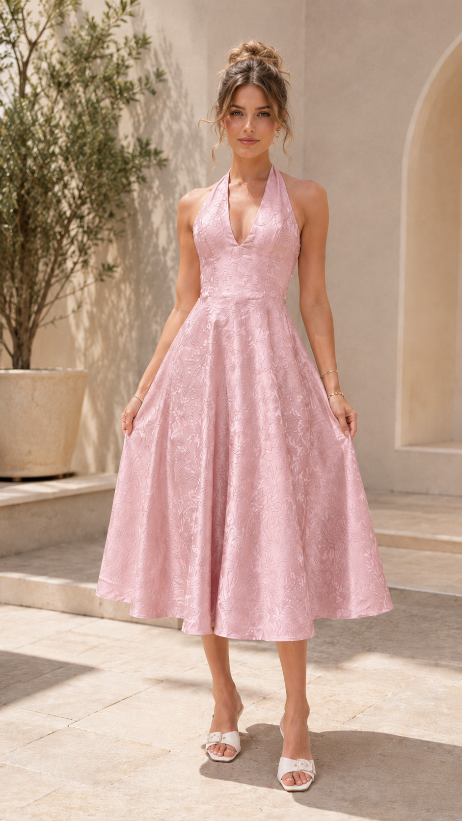 Front view of blush pink halter midi A-line dress with textured finish