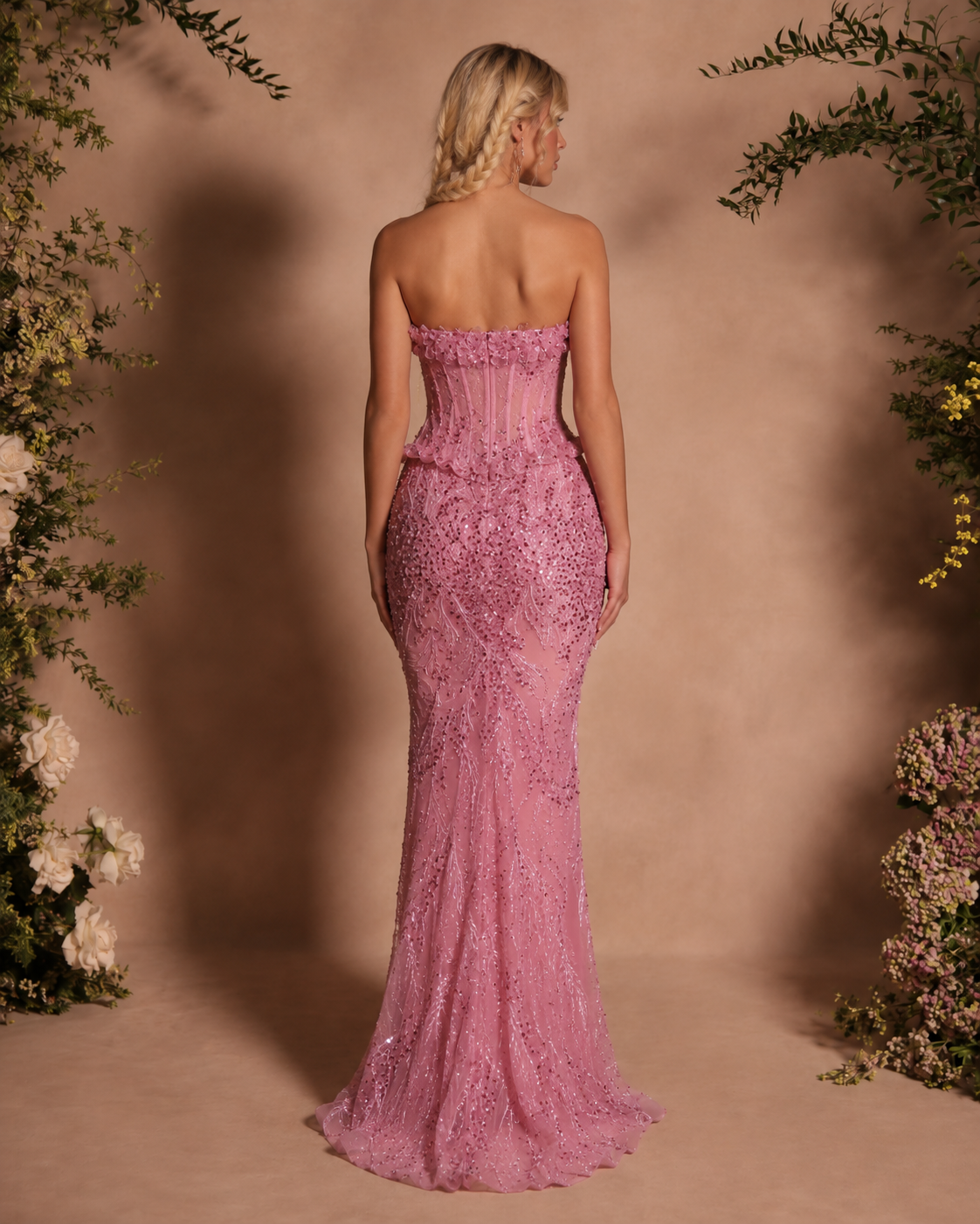 Back view of blush pink strapless mermaid gown with fitted embellished skirt