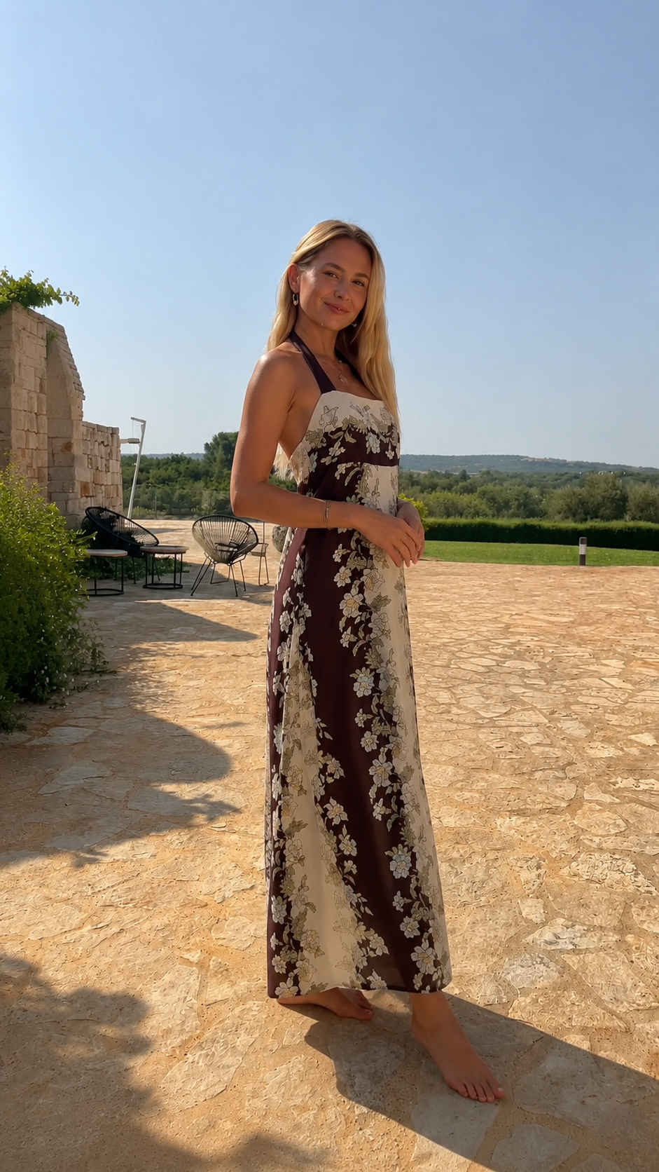 Side view of chocolate and cream floral halter maxi dress