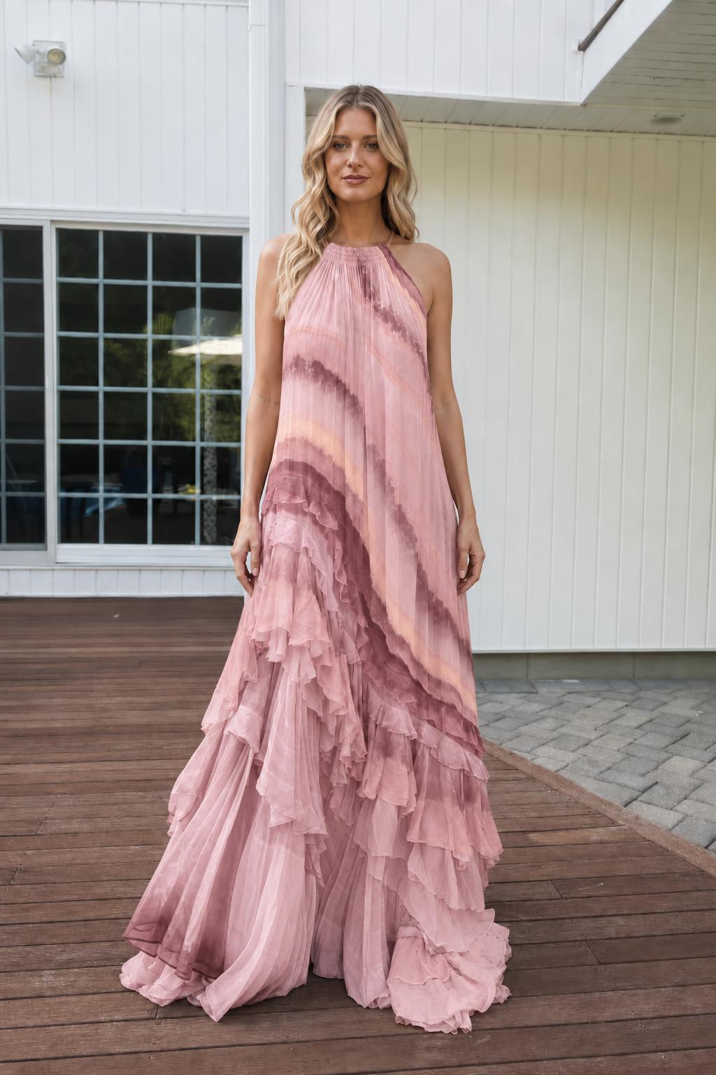 Model wearing solid blush pink pleated halter maxi dress